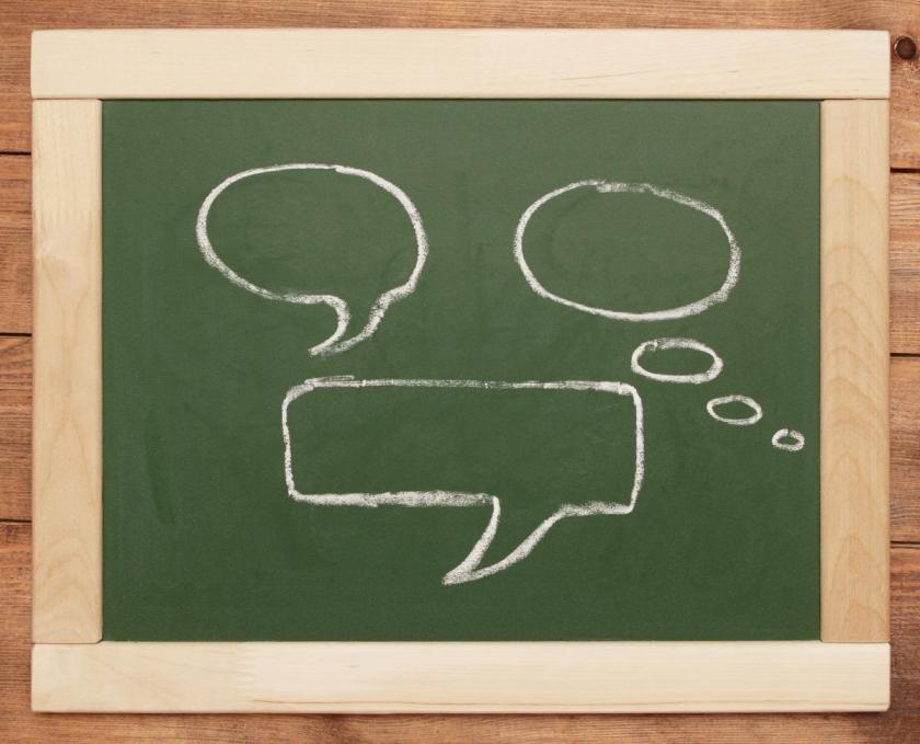 thought and speech bubbles drawn in chalk on a blackboard